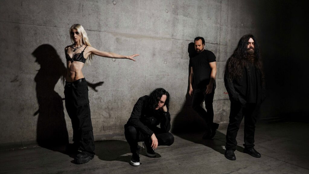 A promotional image for The Pretty Reckless concert at The Midland Theatre in Missouri, featuring the band performing on stage.