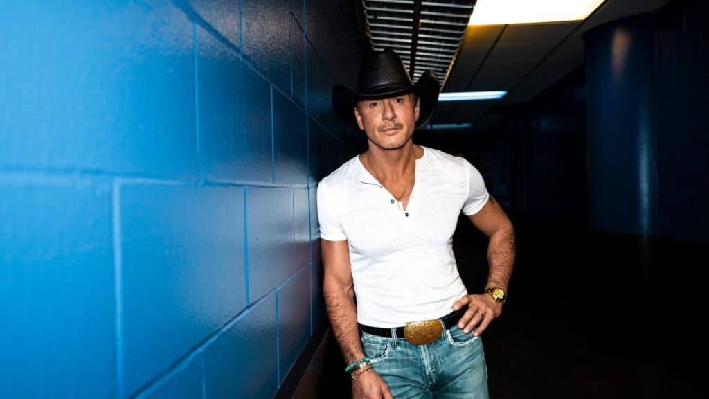 Tim McGraw performing on stage during the Pawn Shop Guitar Tour, with fans enjoying the live country music atmosphere.
