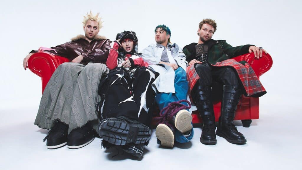 Promotional image for 5 Seconds of Summer concert at Morton Amphitheater featuring band members performing on stage.
