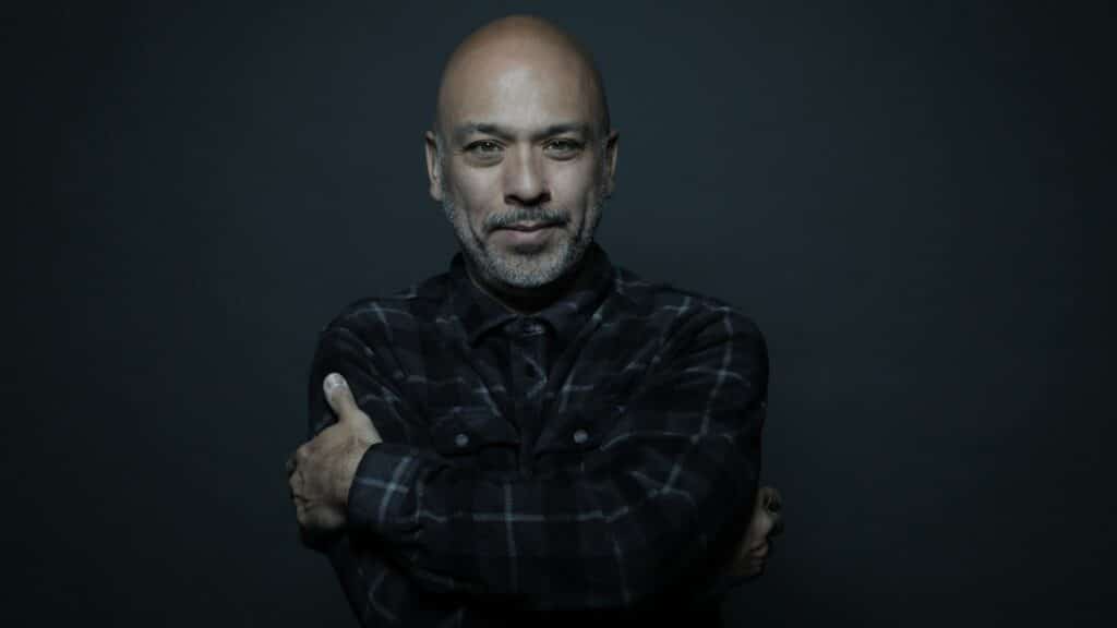 Jo Koy performing comedy live on stage at The Midland Theatre, with an audience enjoying the show.