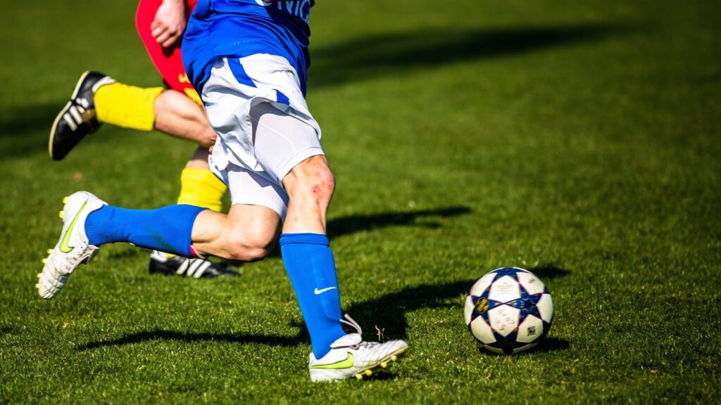 A poster for ALTA JODA FEST MUNDIAL featuring a soccer ball and vibrant colors announcing the event at Uptown Theater.